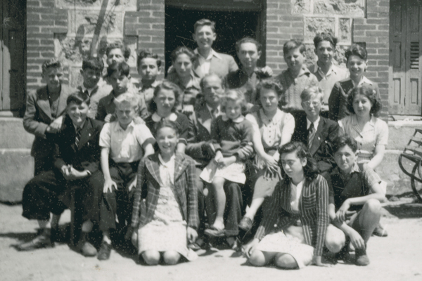 Peter Feigl (second row, far left, black suit) survived the Holocaust thanks to shelter provided by the people of Le Chambon-sur-Lignon and surrounding communities. US Holocaust Memorial Museum, courtesy of Peter Feigl