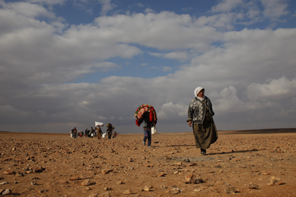 Refugees from Syria cross the border into Jordan. Lucian Perkins for the US Holocaust Memorial Museum
