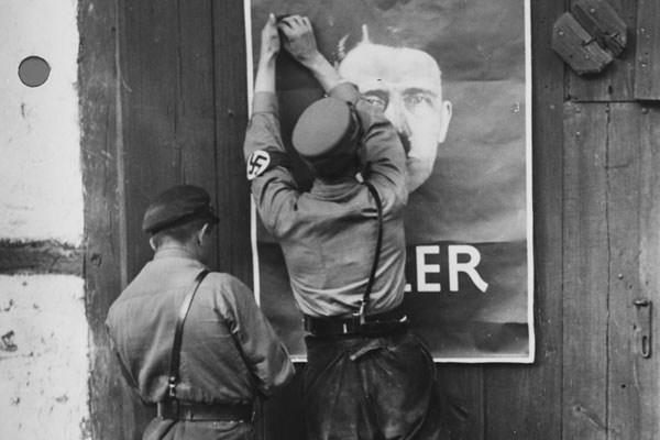 Nazi stormtroopers put up a poster for the 1932 election. Bundesarchiv, Bild 146-1978-096-03 / photo: o.Ang