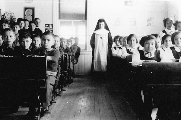 Classroom in the Fort Alexander Indian Residential School, Manitoba, Canada, circa 1949. Theodore Fontaine, who was incarcerated for 12 years in two Indian residential schools, is pictured in the second row, visible between the two boys in the front row. Courtesy of Theodore Fontaine