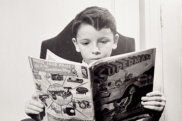 A boy from Germany reads a comic book at a school for refugee children in New York, 1942. Library of Congress, Marjory Collins
