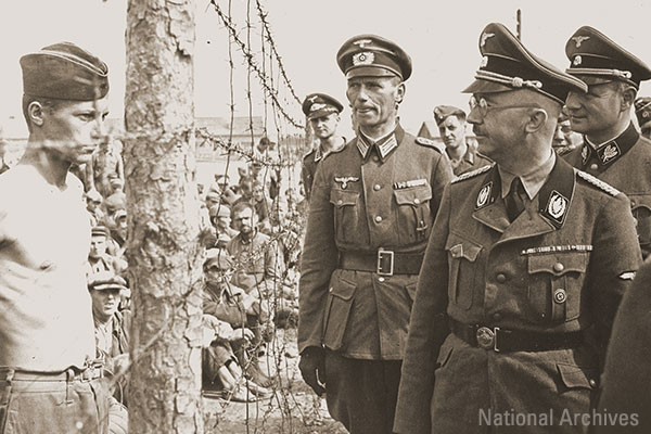 Heinrich Himmler looks at a young Soviet prisoner during an official visit to a POW camp in the vicinity of Minsk. National Archives