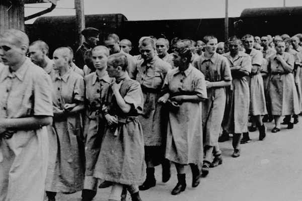 Jewish women, selected for forced labor at Auschwitz-Birkenau, march toward their barracks after disinfection and head shaving. US Holocaust Memorial Museum, courtesy of Yad Vashem 