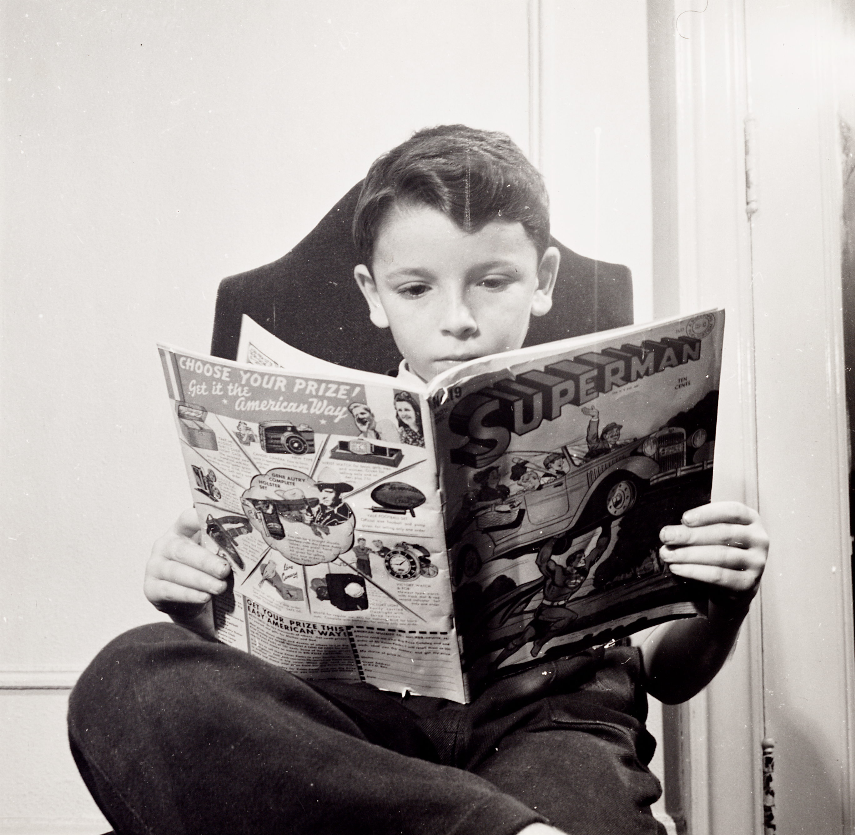 A boy from Germany reads a comic book at a school for refugee children in New York, 1942. Library of Congress, Marjory Collins