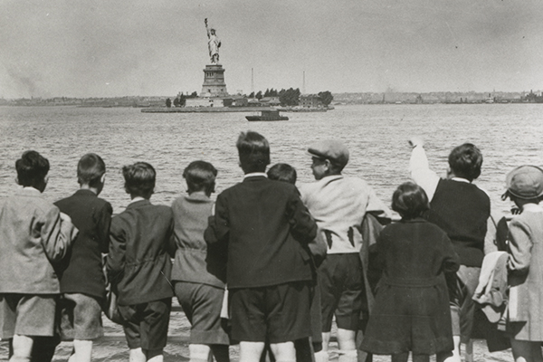 Jewish refugee children aboard the SS President Harding look at the Statue of Liberty as they enter New York harbor, June 1939. Americans Gilbert and Eleanor Kraus brought them to the United States as part of a rescue effort. US Holocaust Memorial Museum, courtesy of Steven Pressman