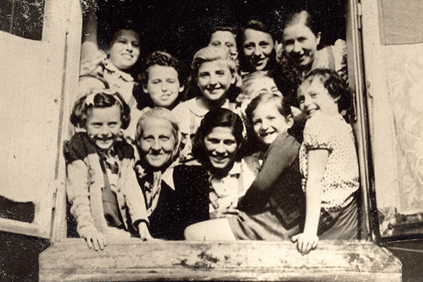 Stella Rein, headmistress of a school in the Łódź ghetto, poses with some of her female students, circa 1940–41. USHMM, courtesy of Arie Ben Menachem