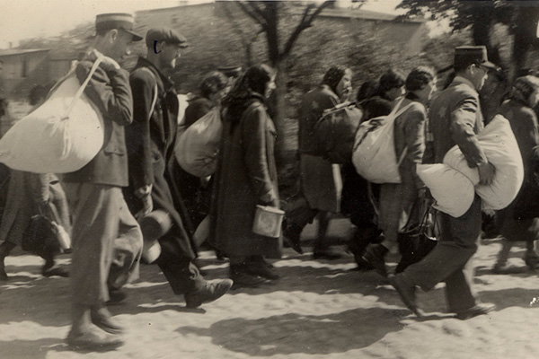 Jewish police escort a group of Jews who have been rounded up for deportation in the Ł&oacute;dź ghetto, June 1944. US Holocaust Memorial Museum, courtesy of Jehuda Widawski