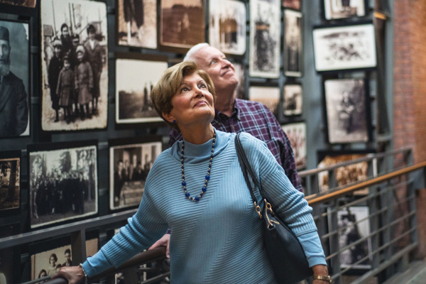 Museum visitors view the Tower of Faces in the permanent exhibition.&nbsp;Daryl Taylor for United States Holocaust Memorial Museum.