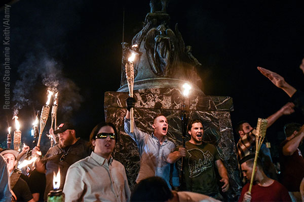White nationalists participate in a torch-lit march on the grounds of the University of Virginia ahead of the Unite the Right Rally in Charlottesville, Virginia, on August 11, 2017. Stephanie Keith/Reuters/Alamy