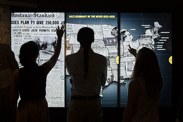 Museum visitors interact with a display in the Americans and the Holocaust exhibition. US Holocaust Memorial Museum
