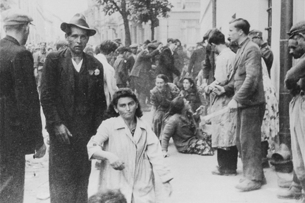 Civilians terrorize Jewish women during the June 1941 pogrom in German-occupied Lviv, part of present-day Ukraine. German soldiers can be seen in the background. US Holocaust Memorial Museum, courtesy of Instytut Pamięci Narodowej 